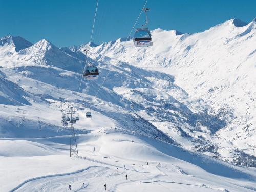 a ski lift flying over a snow covered mountain at Haus Annakogl und Haus Barbara in Obergurgl