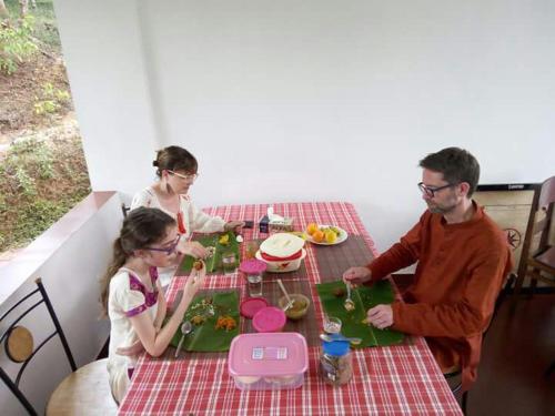 a group of people sitting at a table at THE SUVISTARA WAYANAD KERALA in Meenangadi