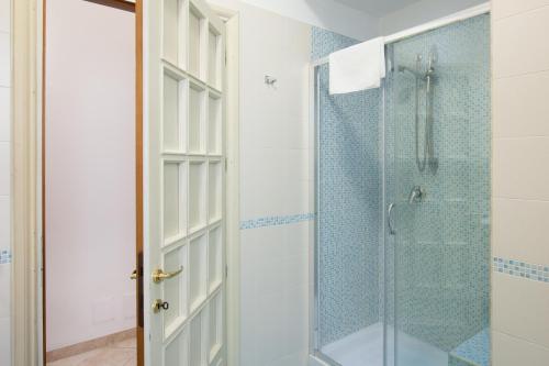 a bathroom with a shower and a glass door at L'Insolita Reggia in Caserta