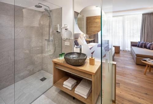 a bathroom with a shower and a sink in a room at Das KATSCHBERG Superior in Katschberghöhe