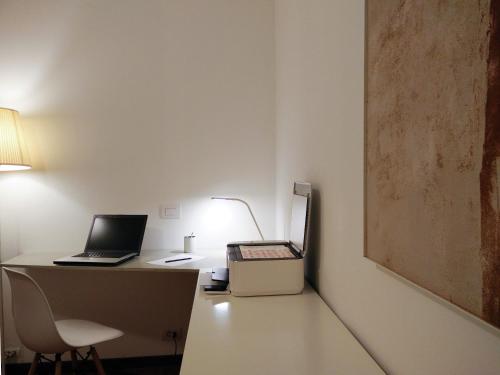 a desk with a laptop computer on top of it at Soardi Accommodation for business & funny in Rimini