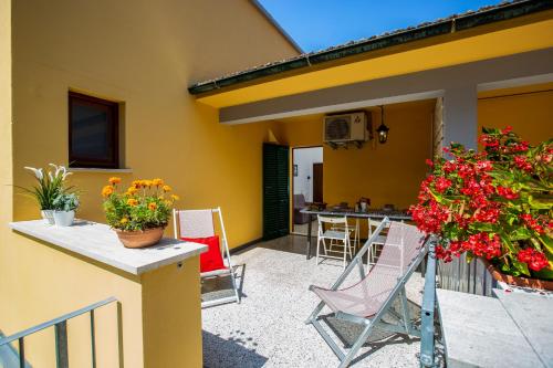 a patio with chairs and flowers on a house at Casa Donatella in Montecchio