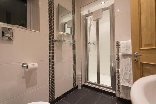 a bathroom with a shower and a toilet and a sink at Stratford Limes Hotel in Stratford-upon-Avon