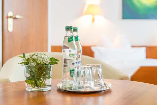 a table with two bottles and two glasses on it at Mayers Waldhorn - zwischen Reutlingen und Tübingen in Tübingen