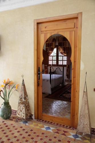 a door to a room with a crib and christmas trees at Rive Du Lac in Lalla Takerkoust