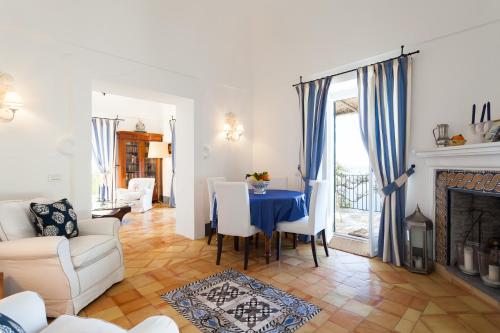 a living room with a table and a fireplace at Casa Bellevue in Positano
