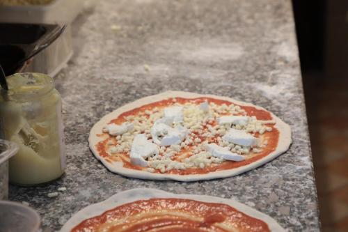 a uncooked pizza sitting on top of a counter at Hotel Ristorante Château in Aymavilles