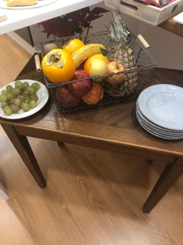 a table with a basket of fruit on it at Boutique Hotel Palazzo Corso Umberto in Boiano