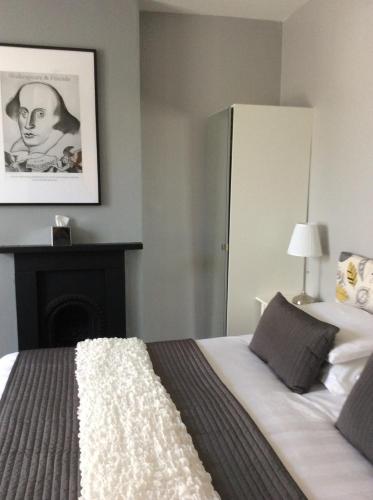 a bedroom with a bed with a fireplace in it at Hedley Villa Guest House in Leamington Spa