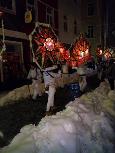 a person holding a decorated elephant in the snow at Apartmenthaus Hinterer in Bad Goisern