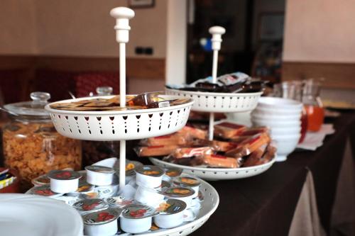 a buffet of food on a table with plates of food at Hotel Ristorante Château in Aymavilles
