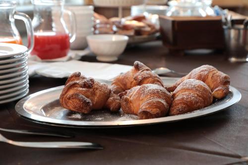 a plate of croissants and other pastries on a table at Hotel Ristorante Château in Aymavilles