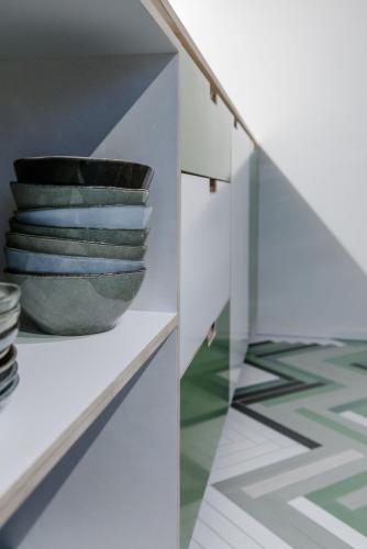 a room with a shelf with a vase on it at The Hide in Ghent