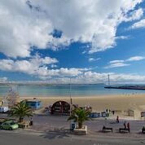 a view of a beach with a building and the ocean at The Fairhaven Hotel in Weymouth