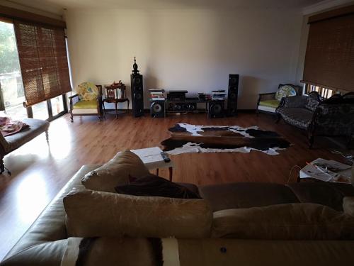 a living room with couches on the floor at Ekhaya Guest House in Ballito