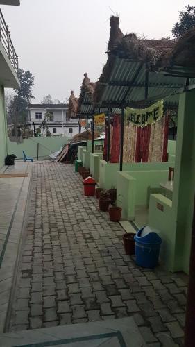 a brick walkway with buckets on the side of a building at Nayathali Hotel & Lodge Pvt. Ltd in Kawasoti