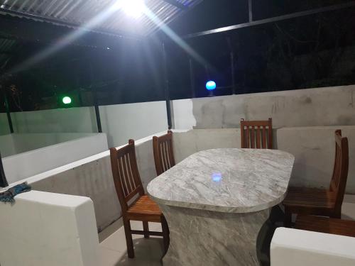a table and chairs in a room with lights at Nayathali Hotel & Lodge Pvt. Ltd in Kawasoti
