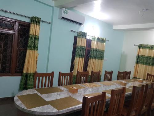 a dining room with a long table and chairs at Nayathali Hotel & Lodge Pvt. Ltd in Kawasoti