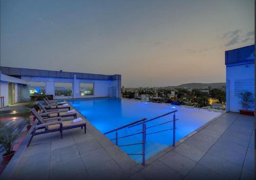a large swimming pool on top of a building at Ramee Grand Hotel and Spa, Pune in Pune