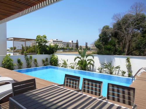 a pool on the roof of a house at Plage Residences in Paphos