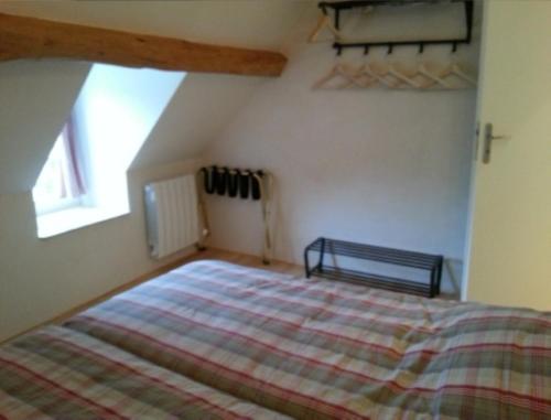 a bedroom with a large bed in a attic at Gite Allier in Montaigu-le-Blin