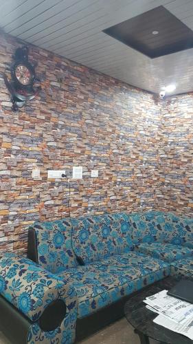 a couch in a room with a brick wall at Nayathali Hotel & Lodge Pvt. Ltd in Kawasoti