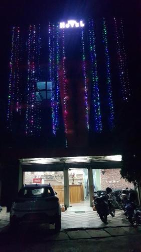 a car parked in front of a building with christmas lights at Nayathali Hotel & Lodge Pvt. Ltd in Kawasoti