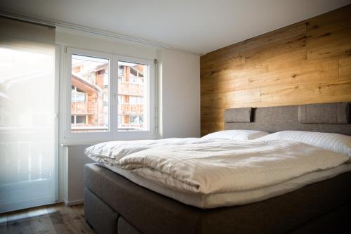 ツェルマットにあるBolero 3.5のベッドルーム1室(大型ベッド1台、木製ヘッドボード付)