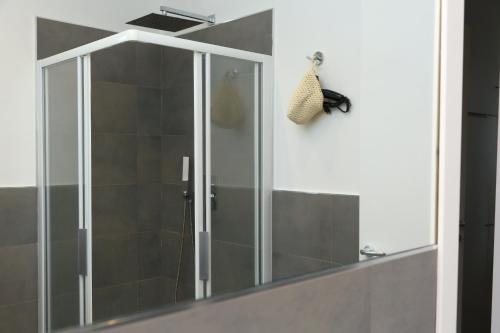 a shower with a glass door in a bathroom at casa verdemare in Cefalù