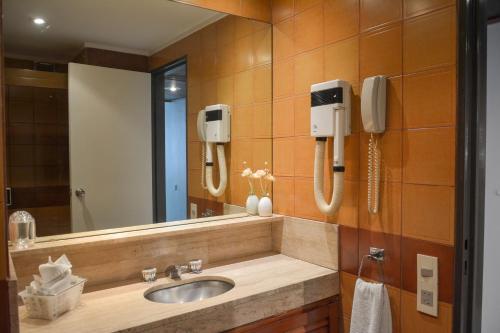 a bathroom with a sink and a mirror at Edificio Corrientes 1856 in Buenos Aires