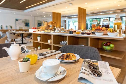 a table with a plate of food on top of it at Bordoy Alcudia Port Suites - Adults Only in Port d'Alcudia