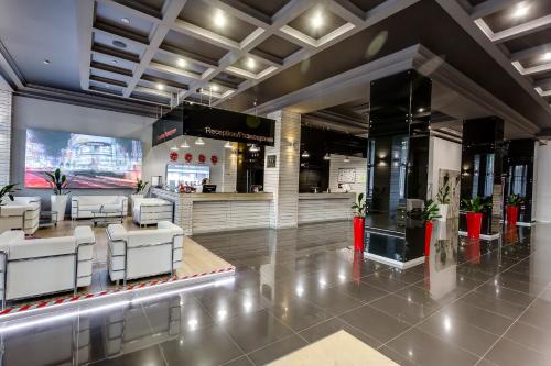 a lobby of a restaurant with white chairs at Marins Park Hotel Rostov in Rostov on Don