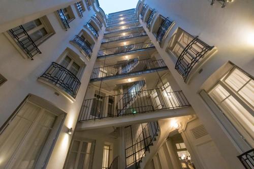 a large white building with a staircase on it at Résidence Charles Floquet in Paris