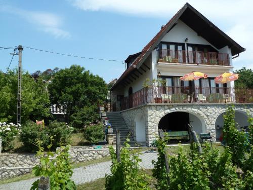 a house with a balcony and a patio at House Sophie in Vonyarcvashegy