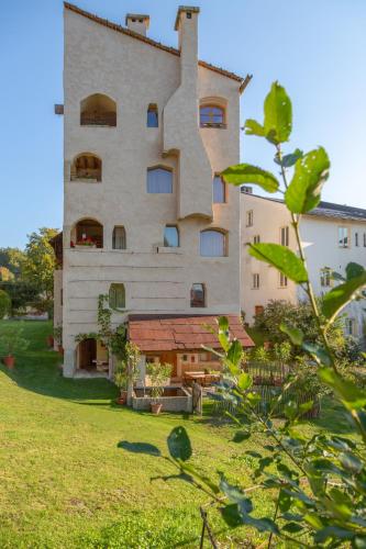 a large building with a grassy yard in front of it at Turm zu Schloss Schedling in Trostberg an der Alz