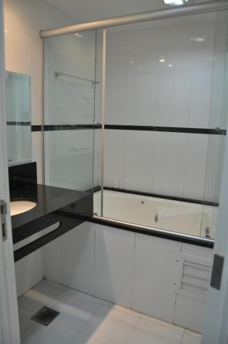 a kitchen with white cabinets and a glass wall at GOLD MARTAN HOTEL in Belém