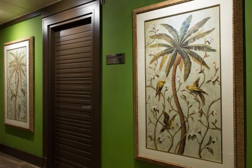 a hallway with green walls and a large painting of plants at Grand Hotel Cavour in Florence