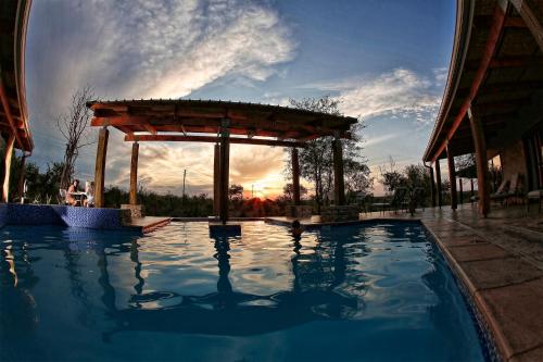 赫克托斯普雷特的住宿－基里卡拉帕山林小屋，一个带凉亭的游泳池,享有日落美景