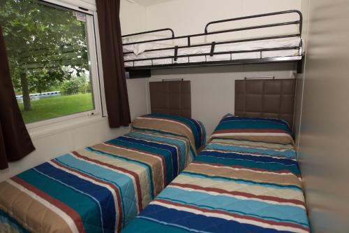 Tempat tidur dalam kamar di Campeggio Smeraldo
