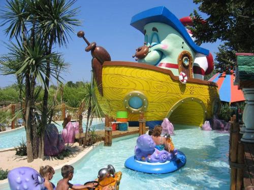a group of children on a water slide at a water park at Ashanti Garden Luxury Short Term Rental Duplex Altea in La Nucía