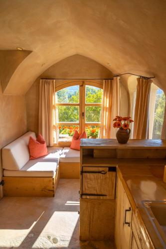 a small room with a couch and a window at Turm zu Schloss Schedling in Trostberg an der Alz