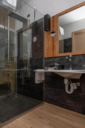 a bathroom with a sink and a shower at Hotel Chaberton in Cesana Torinese