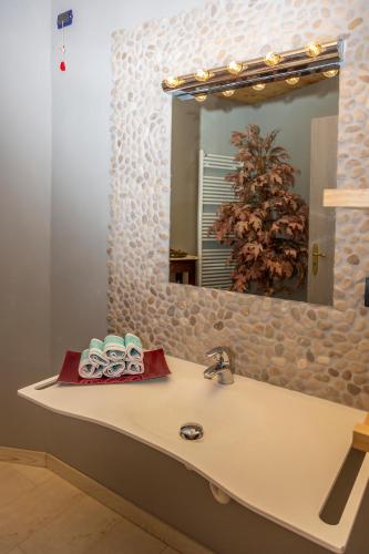 a bathroom with a sink and a mirror at Hotel Chaberton in Cesana Torinese
