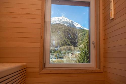 a window in a room with a mountain view at Hotel Chaberton in Cesana Torinese