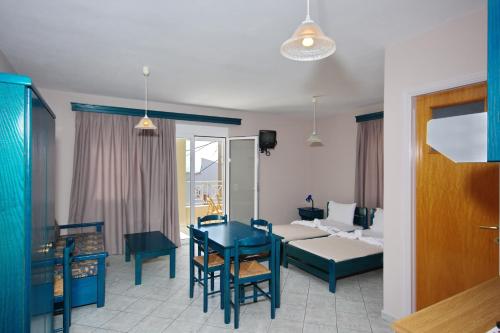 a living room with a table and a couch at Athanasia Studios in Patitiri