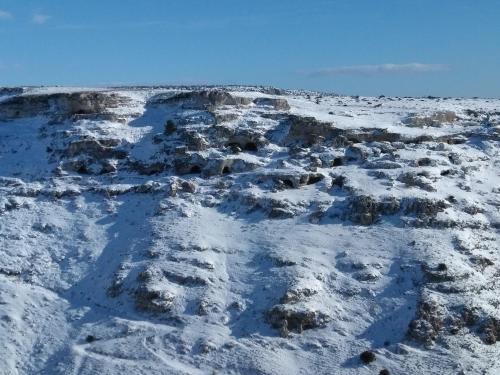 a snow covered hill with footprints in the snow at Bed And Breakfast Nelmuro in Matera