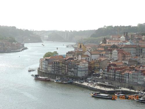 a city with buildings and boats in the water at House In Aguda Beach, praia da Aguda, in Aguda