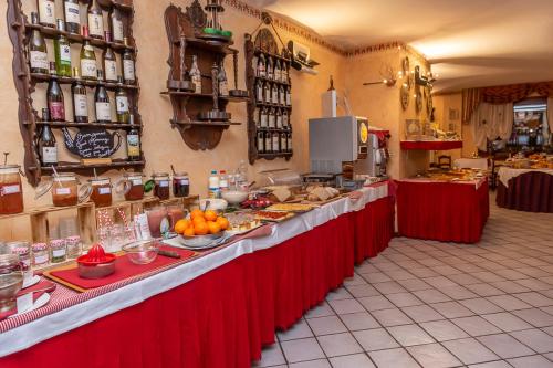 a long counter in a kitchen with food on it at Hotel Chaberton in Cesana Torinese