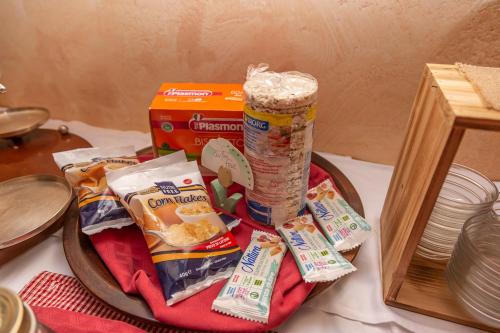 a table with a plate of food and a box of food at Hotel Chaberton in Cesana Torinese