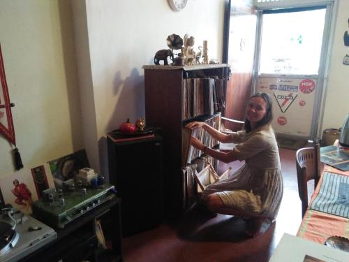 a woman sitting in a chair in a room at Mini's Residence in Colombo
